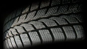 Detailed close-up image of a rubber tire showcasing texture and tread pattern, ideal for design concepts.